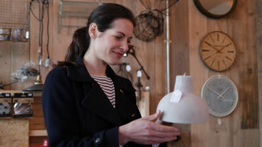 Adult female looking at price tag in a home store