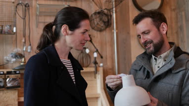 Couple looking at price tags in a home store