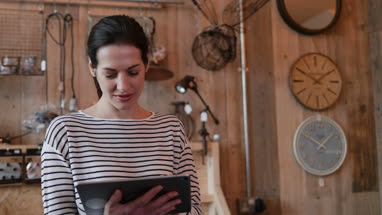 Small business owner using digital tablet in a store
