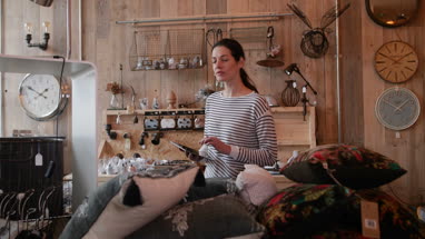 Portrait of small business owner holding digital tablet in a home store