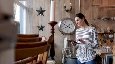 Portrait of small business owner holding digital tablet in a home store
