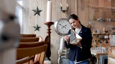 Adult female looking at price tags in a vintage antique store