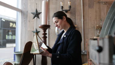 Adult female looking at price tags in a vintage antique store