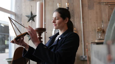Adult female looking at price tags in a vintage antique store