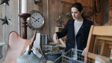 Adult female looking at price tags in a vintage antique store