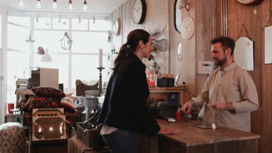 Customer paying with credit card in a home store