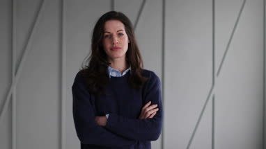 Testimonial portrait of mid adult female looking to camera