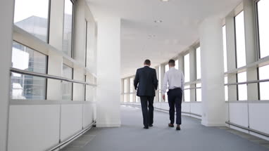 Businessmen walking away from camera
