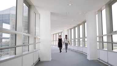 Businesswomen walking through office having a meeting