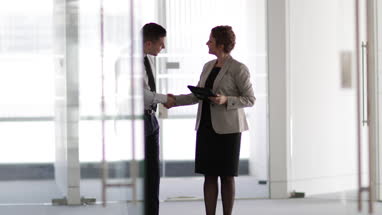 Businessman shaking hands with relator in new office space