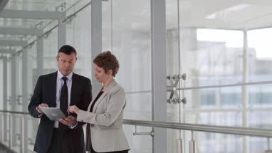 Business people having meeting in modern office using digital tablet