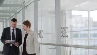 Business people having meeting in modern office using digital tablet