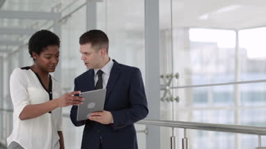 Business people having meeting in modern office using digital tablet