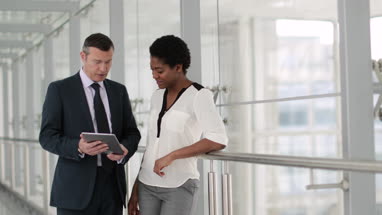 Business people having meeting in modern office using digital tablet