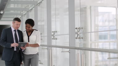 Business people having meeting in modern office using digital tablet