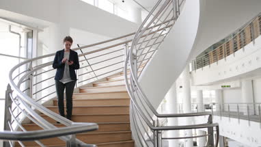 Businesswoman using smartphone in modern office