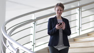 Businesswoman using smartphone in modern office