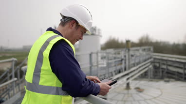 Industrial worker using a digital tablet on site