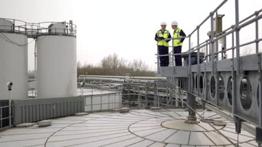 Industrial workers using a digital tablet on site