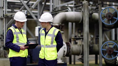 Industrial workers using a digital tablet on site