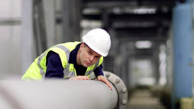 Industrial worker checking pipeline