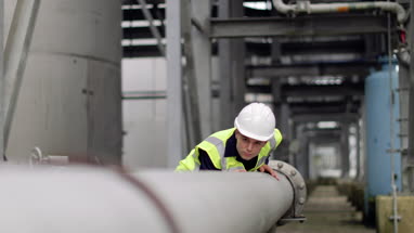 Industrial worker checking pipeline