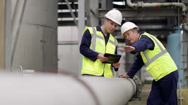 Industrial workers using a digital tablet on site