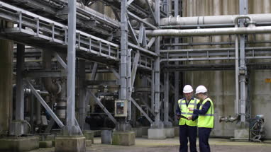 Industrial workers using a digital tablet on site
