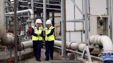 Industrial workers using a digital tablet on site