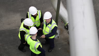 Overhead shot group of industrial coworker workers on site with digital tablet