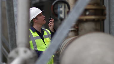 Industrial worker using radio on site