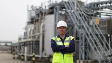 Portrait of mature industrial worker on site