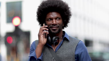 African American male talking on smartphone on his commute