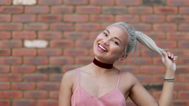 Young adult female posing for photo on street