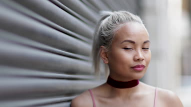 Portrait of young adult female with urban background