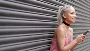 Young adult female messaging on smarphone