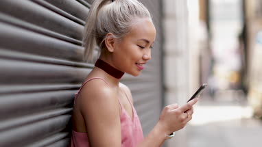 Young adult female messaging on smarphone