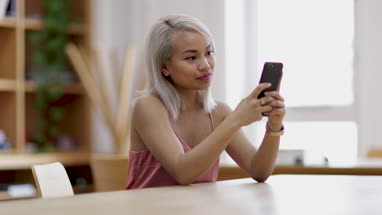 Young adult female using smartphone in college