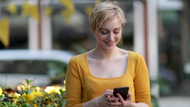 Young adult female laughing at smartphone