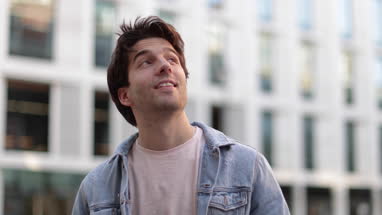 Portrait of young adult male tourist in city