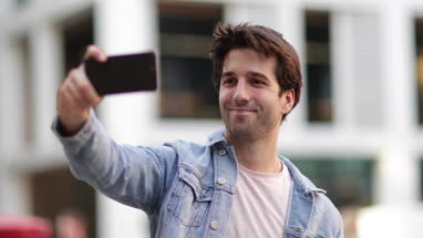 Young adult male tourist posing for selfie