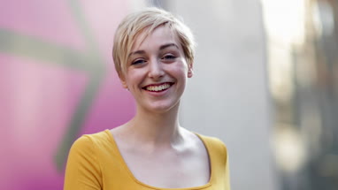 Portrait of young adult female with arrow sign in background