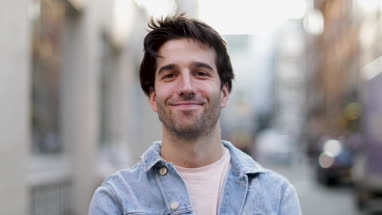 Portrait of young adult male on street