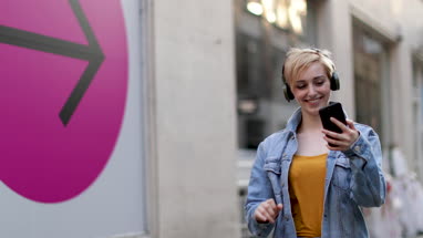 Young adult female taking selfie with street art