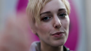 Young adult female taking selfie with street art