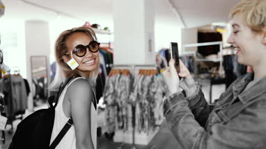 Millennials looking at smartphone in a vintage store