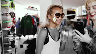 Millennials looking at smartphone in a vintage store