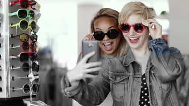 Millennials looking at smartphone in a vintage store