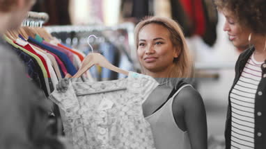 Millennial female friends shopping in a vintage clothing store