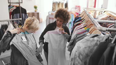 Millennial female friends shopping in a vintage clothing store